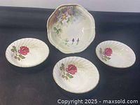 Photo showing all four bowls together: one large bowl with purple flowers, three smaller bowls with red roses.