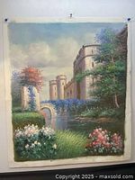 Full view of the oil painting depicting castle with towers, foliage, flowers and water body in natural setting.