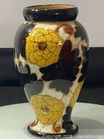 Front view showing yellow flowers and dark leaves on cream background.