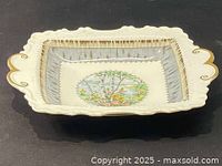 Top view showing the rectangular dish with decorative handles, gold trim, and a central hand-painted scenic design of birch trees and wildflowers.