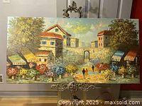 Full view of oil painting showing colorful village scene with buildings, stone wall and archway, flower stands, trees, and three figures walking on the path.