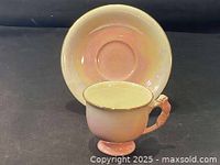 Pink Royal Winton teacup inside matching saucer showing cup's interior and saucer base.