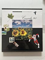 Book cover of the 1995 Canada stamp collection with artwork and title.