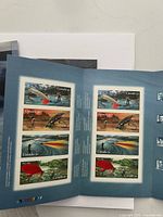 Booklet of fish-themed Canada postage stamps showing colorful fish images on stamps inside a blue cover.