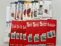 Multiple 5 cent Canadian postage stamp booklets and sheetlets, featuring various designs and themes in original packaging.