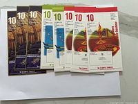 Photo of eight Canada Post stamp booklets and sheets with various mineral and holiday themes, unopened and arranged in a row across a white surface