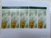 Five sealed booklets of Canada Post international stamps, each with 5 stamps, showing front views.