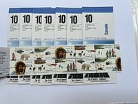 Photo showing 8 booklets of Arctic wildlife themed Canadian postage stamps, sealed and unused.