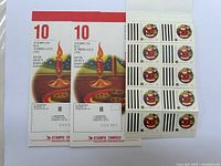 Three sheets of Canadian postage stamps with candle and cookies design, $0.37 denomination