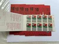 Sheet of 10 Canadian Christmas themed stamps featuring Santa Claus and green and white striped background, face value $1 each.