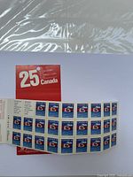 Two sheets of 25-cent Canadian stamps featuring beaver design in a booklet.