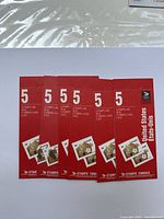Five unopened 5 CAD Canada Post stamp booklets with Olympic-themed stamps on red covers.
