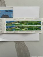 Full strip of four Canada stamps depicting Fortress of Louisbourg aerial view on backing paper.