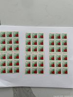 Three sheets of Canada postage stamps with a stylized red maple leaf design, mint and unused.