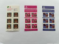 Photo showing three blocks of mint unused Canadian postage stamps in different designs, face values marked as $6, $6.50, and $6 each.