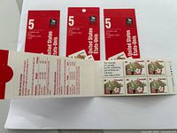 Close-up photo of one pack showing the detail of 5 floral-themed stamps with $0.48 face value each and postal information inside flap.