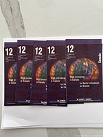 Five purple booklets each marked with number '12' and text 'High technology in Canada'