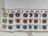 Six sheets of Canadian postage stamps with multiple $5 stamps each, featuring colorful circular designs with various motif and color backgrounds.