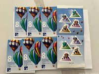 Two sheets of Canadian postage stamps showing colorful hot air balloons, each stamp with 8 cents denomination.
