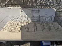 Multiple wire pan warmer racks lined on table with shower rack hanging on backdrop