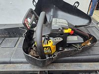 Chainsaw inside cracked hard case showing overall condition