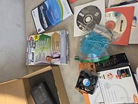 Box and spread of discs, boxed Excel Select Edition, CPU fan and AC adapter visible