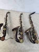 All three metal saxophone sculptures front view