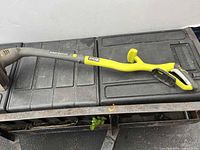 Full view of Ryobi EasyEdge string trimmer body on bench