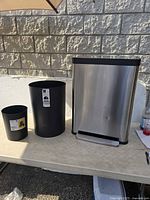 All three trash cans on table