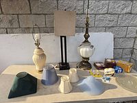 Entire lot showing three lamps, multiple shades, glass covers and bulb packages