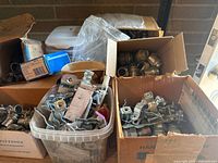 Multiple boxes and containers filled with assorted metal screws, bolts, nuts, washers, and metal fittings.