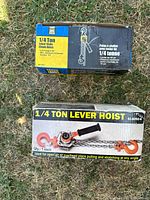 Two boxes of manual chain lever hoists with product labels and specifications.