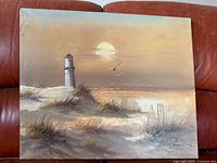 Photo of realism canvas art depicting lighthouse, coastal landscape and sun, signed by artist Remington