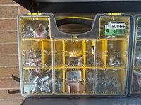 Front view of Stanley organizer with multiple compartments packed with metal conduit connectors of different sizes and types.