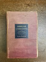 Top view of the front cover of the book showing the title label and worn reddish-brown cloth cover.