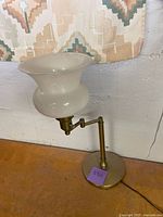 Lamp unlit showing brass base, swing arm, and intact frosted glass shade