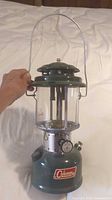 Coleman 200A lantern front view with handle raised