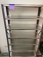Front view of full shelving unit showing 8 shelves and slotted uprights