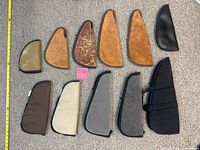 All 11 gun cases laid out, showing shapes, materials and relative sizing