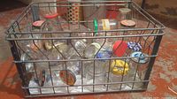 Front view showing metal crate filled with various glass jars and coloured lids