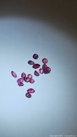 Multiple natural ruby gemstones in varied shapes and sizes, loose and untreated.