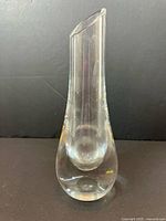 Front view of clear teardrop-shaped crystal vase with slanted rim