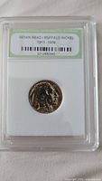 Front of encapsulated Indian Head/Buffalo nickel showing label from International Numismatic Bureau.