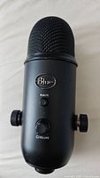 Front view of Blue Yeti microphone showing mute button and volume knob.