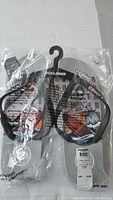 Front view of Jack & Jones flip flops in original plastic packaging attached to black hanger, showing overall product and branding.