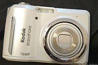 Front view of Kodak Easyshare camera showing the lens, built-in flash, and 16MP marking.