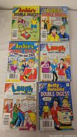 Top view of six comic books including Archie Double Digest, Laugh Digest Magazine, and Betty and Veronica Double Digest.