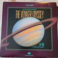 LaserDisc titled The Voyager Odyssey dated 1977-1999 with image of the planet Saturn on cover.