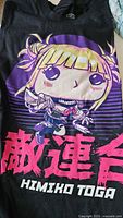 Front view of black T-shirt showing colorful Funko Pop style graphic of Marvel character Himiko Toga with Japanese text and character name.