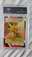 Holographic Zapdos Pokémon card graded 10 Gem Mint in protective casing with Blue Diamond Diamonds label